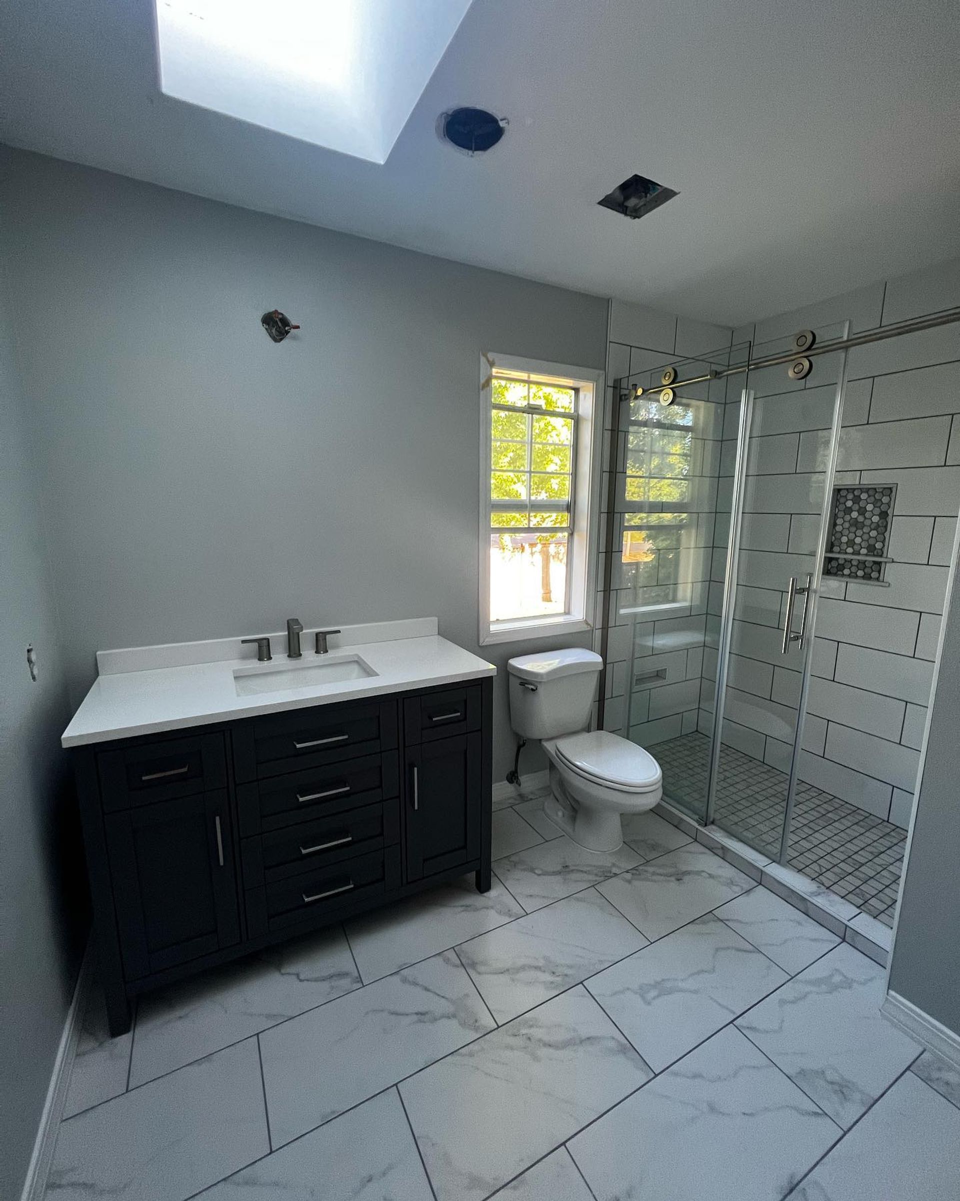 shower, vanity, and bathroom tile
